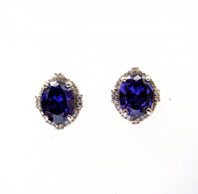 Creation Diamond/Tanzanite Earrings 7.44Ct 18k W/g Overlay: Gem: Creation Diamond/Tanzanite Item: Earrings Center stone: 6.74 carat oval shape, size 10x8mm (Clarity: VSI, Color: Dark Violet Blue) 28 Pieces Creation Diamond: .70 carat round (Clarity: VSI, Color