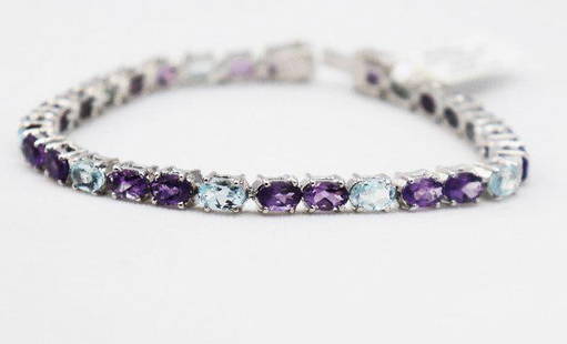 Multi-Color Bracelet 15.4 CT 18K W/g Overlay: Gem Type: Amethyst, Topaz Weight: 28pieces 15.4 Carat oval shaped (6x4mm) Clarity: Transparent/Opaque Color: Multi-Colored Hardness: 7,8 Length: 7 inches Metal: 14.57 grams 18k white gold overlay<