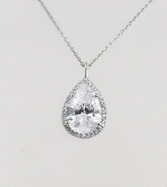 Necklace Creation, Diamond 6.35 Ct 18k W/G Overlay: Gem Type: Creation, Diamond High Quality Item Item: Necklace Center Stone: Approx. 6.01 Carat Pear Shaped, Size: 15x9mm, Clarity: VVS, Color: F Surrounding Stone: Approx. .35 Carat round brilliant, Cl