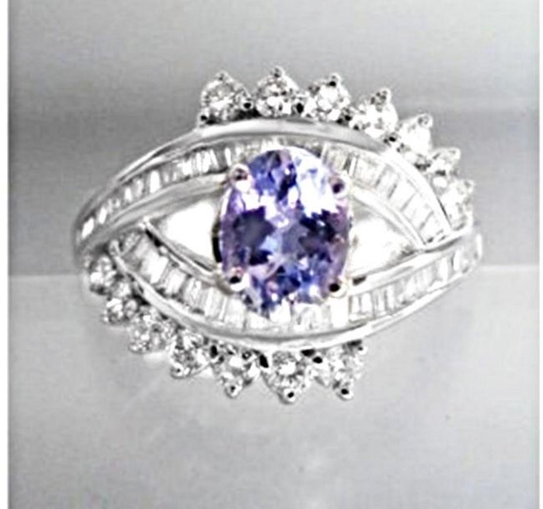 Tanzanite Ring: 1.20CT& Diamond: 1.10Ct 18k W/g: Gem Type: Diamond / Tanzanite Ring Baguette/Round Diamond: 1.10 carat (Clarity: VS2 Color: G) Tanzanite: 1.20 carat genuine Oval shape Composition: Natural: Transparen Color Violet-Blue Hardness 6.5 O