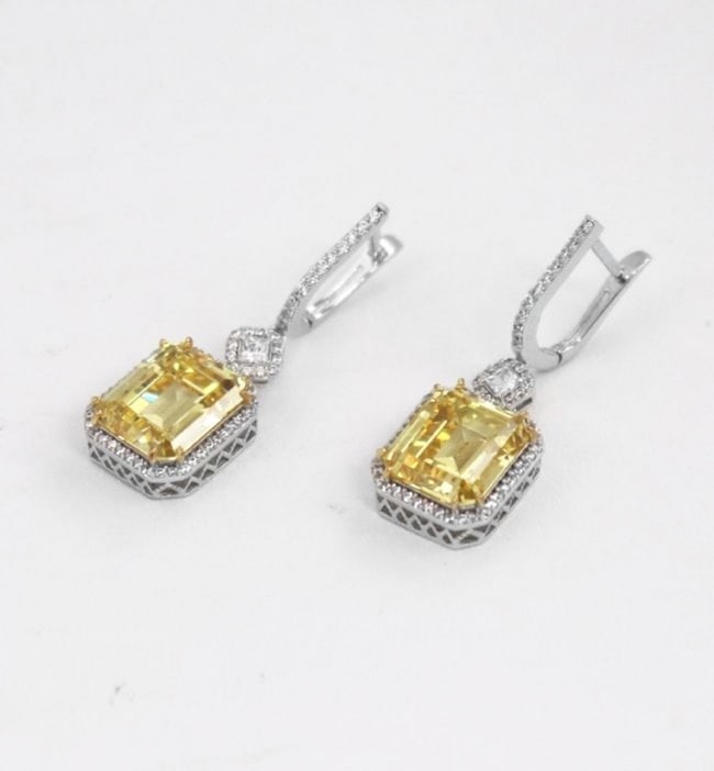 Creation, Y/W Diamond 11.30 Carat 18K W/G Overlay 925: Gem Type: Creation, Fancy Yellow, Creation White Diamond Center Stone: 11.30 Carat, Shaped: Emerald Step cut, Size: 11.70x10x6.5mm Clarity: VSI, Color: F Mounting: Approx. 1. Carat round brilliant Cla