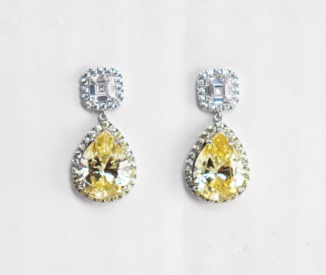 Creation, Y/W Diamond Earrings 6.02 Carat 18K W/G Overl: Gem Type: Creation, Fancy Yellow and White Diamond Center Stone: 6.02 Carat, Shaped: Pear shaped Clarity: VS1, Color: F Mounting: Approx. 1.50 Carat Cushion cut and round