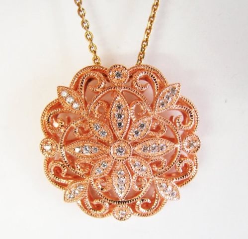 Creation Diamond Scallop Pendant .39Ct 18k R/g Overlay: Creation Diamond Pendant High Quality Item Item : Pendant Light: 1" x 8mm Thickness 45 Pieces Weight: .39 carat (Clarity: VVS1, Color D) 18k Rose gold overlay 925 silver Weight: 8.94 grams Color: Rose