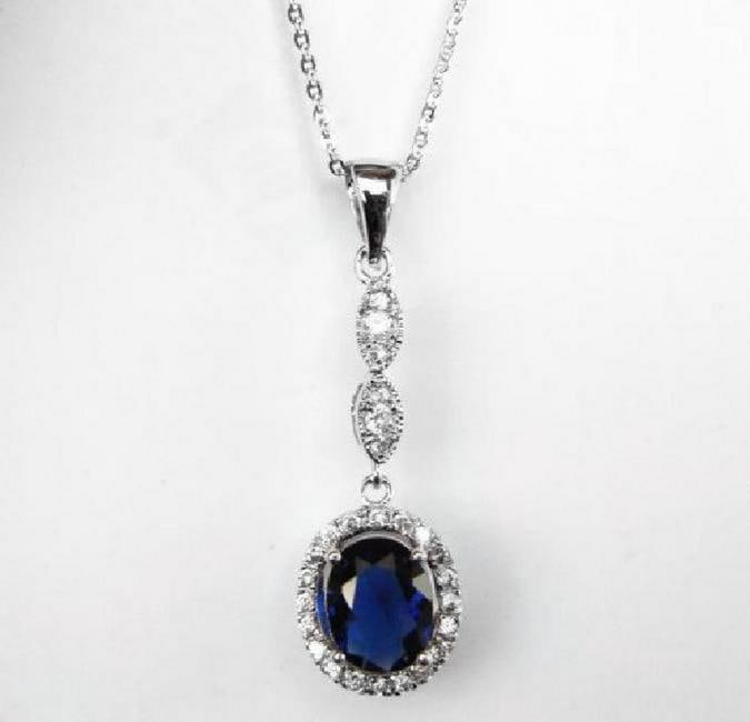 Creation Diamond/Blue Sapphire Pendant 1.93Ct 18k W/g overlay: Gem: Creation Diamond/Blue Sapphire Item: Pendant Center stone: 1.50carat oval shape, size 8x7mm (Clarity: VSI, Color: Blue) Creation Diamond: .43 carat round (Clarity: VSI, Color: E) Metal: 18k white