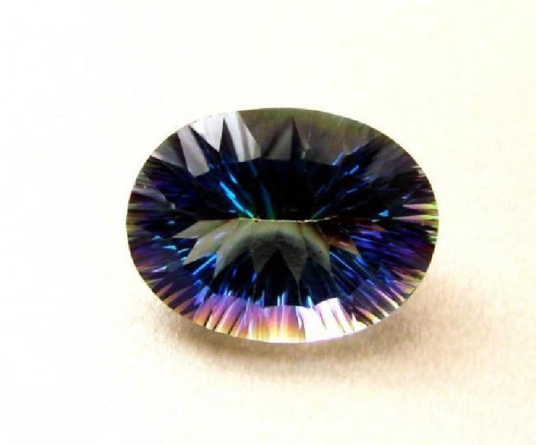Top Rainbow Natural Mystic Topaz Oval Concave 17.55Ct: Gems Type: Rainbow Mystic Topaz Weight:17.55 carat Measurement:20x15x10.8 mm Clarity: VVS, Color: Top Rainbow, Treatment: Coated Cut: Oval Concave, Luster: Fine, Hardness: 7 Origin: Brazil-Estimated V