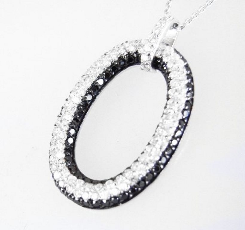 Creation Diamond W/B 1.00 CT Necklace 18k Y/G Overlay: Gem: Creation White/Black Diamond Qty: 1 Item: Necklace Length: 18." Pendant size: L 30Xw20mm Stone weight: 1.00 carat round (Clarity: F/Opaque, Color: G, Black) Metal: 18k white gold