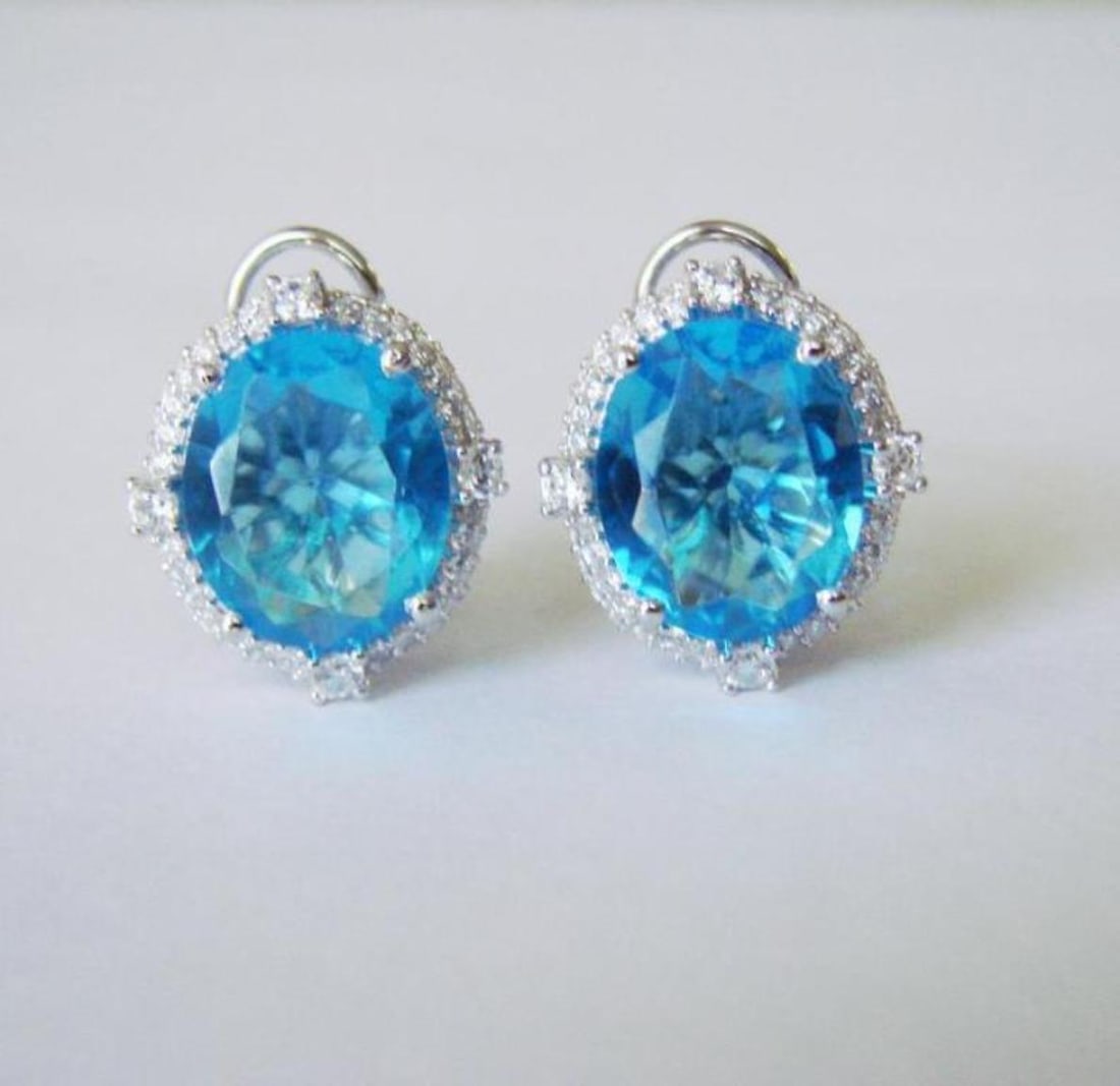 Creation Blue Topaz Dia Earring 13.68Ct 18k W/g Overlay: Creation Blue Topaz Diamond High Quality Item: Earrings 2 Center Weight:11.50 Carat Oval Facet Clarity: VS-Color: Green Measurement:12x10 mm 120 Pieces Creation Diamond Weight:2.18 Carat Round
