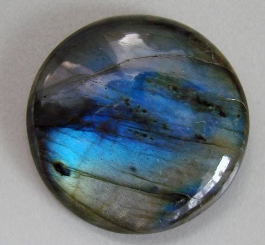 Natural Labradorite Round Cab 79.53Ct 33x8.4mm: Gems Type: Natural Multicolor Labradorite Pear Shape Weight: 79.53 Carat Measurement: 33x8.4 mm Cut: Round Shape Cabochon Clarity: Translucent, Color: Multicolor Treatment: None, Hardness:6 Origin: Ma