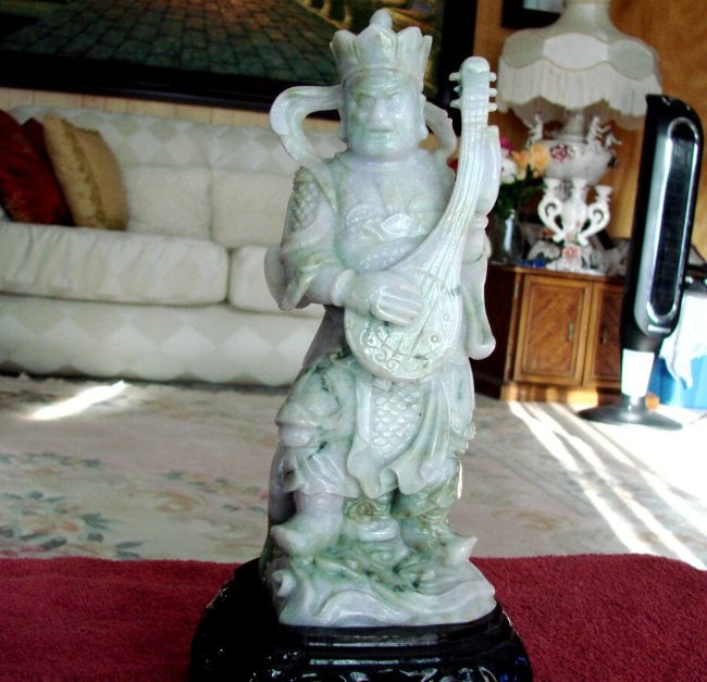 19th Century Jade Carving Famous Dragon Gong Guanyu: Gem:Jade Dragon Gong Guanyu Warrior Statue with a Hand Guitar 19th Century Weight: 3.5 Pounds Height: 9" x Width: 3.5" Color: Light green, Dark Green, Brown Texture Estimated Value Price: $17,900 Stan