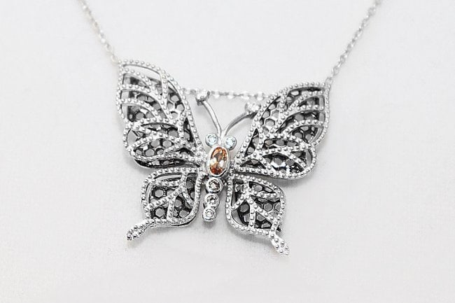 Creation, Diamond Necklace Butterfly Pendant: Creation, Diamond Necklace Butterfly Pendant Gem Type: Creation Diamond white/yellow Weight: .10 Carat round brilliant round shaped White Stone: Clarity: VSI, Color: F, Weight: .65 Carat round