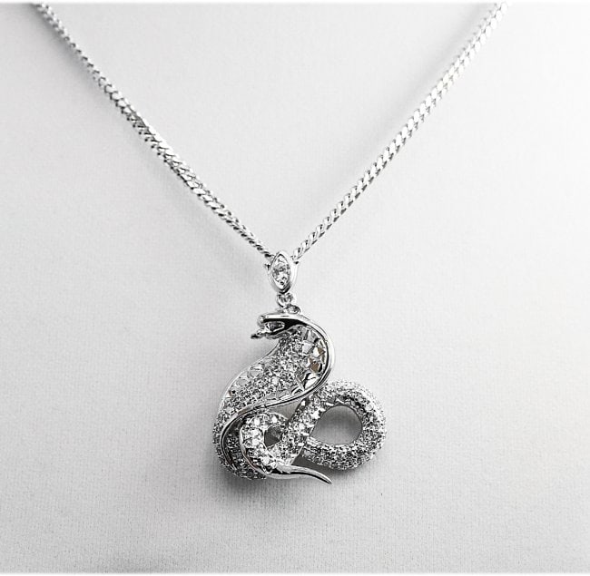 Snake Figure Pendant 18K Whit Gold Overly Brass: Item: Snake Pendant White Stone: Cubic Zirconia round brilliant Metal: 18k white gold overlay Brass Weight: 23.28grams Pendant Size: 45x35mm No chains come with Condition: New High Quality Handmade