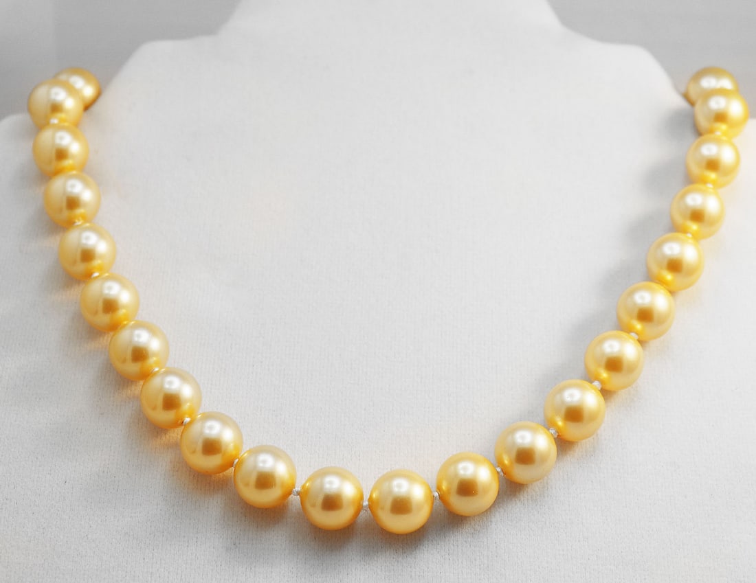 Necklace Swarovski Pearl Necklace 12 mm 925 Ball Clasp: Gems Type: Swarovski Crystal Pearl Measurement: 12 mm, 33 pieces Grade: AAA Color: Golden Swarovski Pearl Luster: Excellent Length: 18 Inches Ball Clasp Knot: Each in Between Threat: Silk <