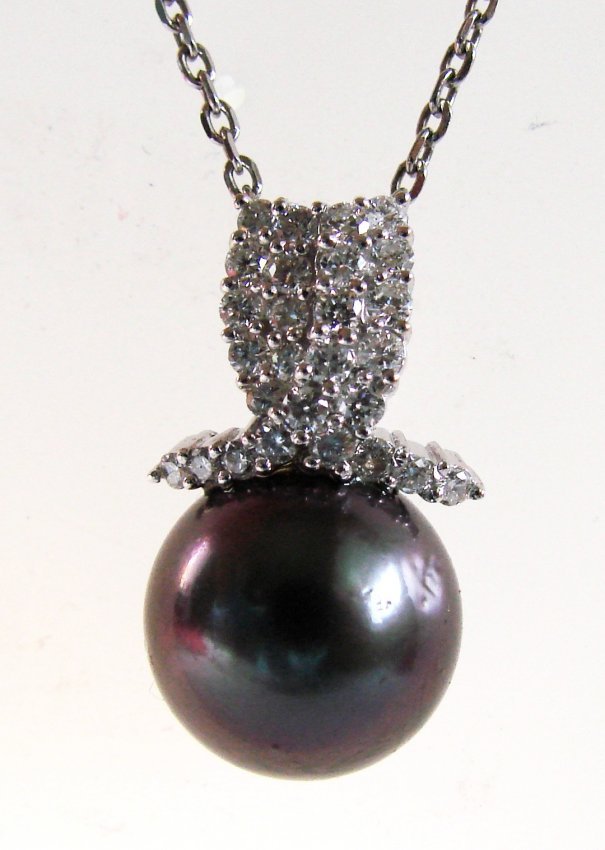 Tahitian Pearl Pendant 12 mm / Dia: .73Ct 18K W/g: Gem Type: Natural Tahitian Pearl Diamonds Pendants Quantity: 1 27 Pieces Round Brilliant Weight: .73 Carat Clarity: VS2 Color: G Tahitian Pearl: 12 mm Round Grade: AAA Color: Peacock, Green,