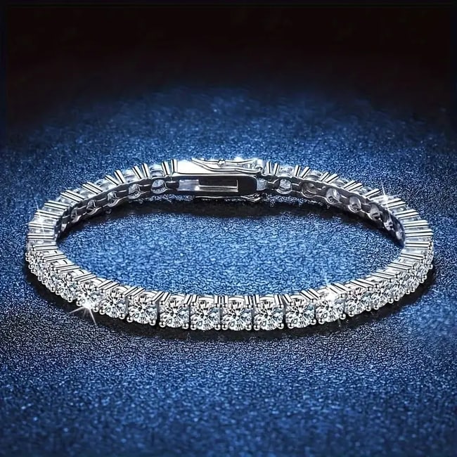 Woman Moisanite Tennis Bracelet 5.50Carat W /g Overlay 925: Gem: Mosisanite 5.50 Carat Round Shape 55pieces Clarity: VVS1 Color: F Metal: 9.37 grams white gold overlay 925 Width: 3mm Lock: Hidden Polish: Excellent Length: 7 inches Available size 7-8 will