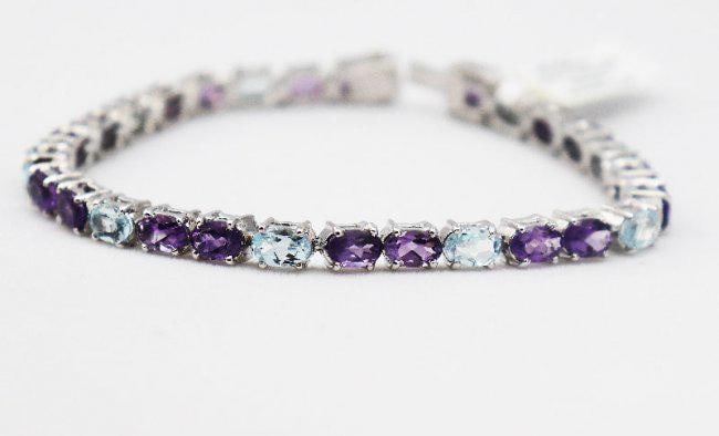 Multi-Color Bracelet 15.4 CT 18K W/g Overlay: Gem Type: Amethyst, Topaz Weight: 28pieces 15.4 Carat oval shaped (6x4mm) Clarity: Transparent/Opaque Color: Multi-Colored Hardness: 7,8 Length: 7 inches Metal: 14.57 grams 18k white gold overlay<