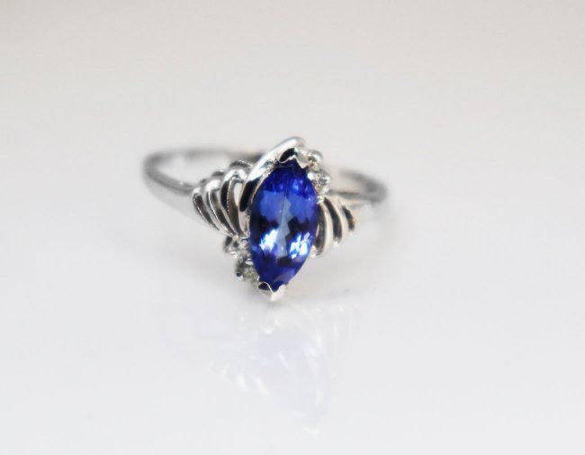Tanzanite & Diamond Ring 1.20T14k W/g: Gem Type: Natural Tanzanite and Diamond Item: Ring, Size: 7 Diamond:.10 carat Round Brilliant and 4 pieces Clarity: SI2, Color: H, Treatment: None Tanzanite 1.10 carat Marquis shaped and 10.5x5.5mm, C