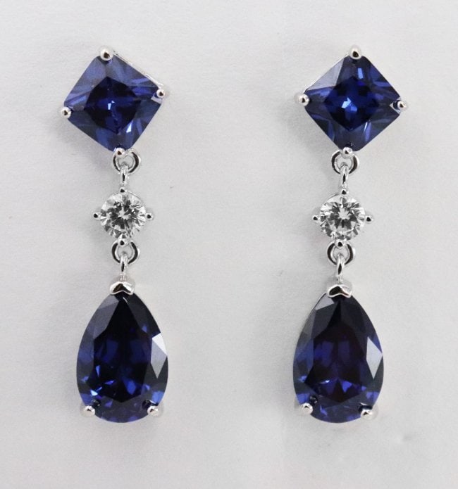 Earrings 11.3 Carat Creation, Blue Sapphire/Diamond 18k: Blue Sapphire: Approx. 5.01 Carat princess cut/6.2 Carat pear shaped Clarity: Transparent, Color: Blue White Stone: Approx.70 Carat round brilliant Clarity: VS1, Color: F Metal:5.20 grams 18k white go