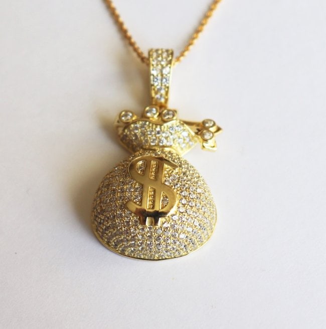 Hip Hop Money Bag Creation Diamond 1.50Ct 18k Y/g Overlay: Pendant: Money Bag Hip Hop Length: 1.50 Inches Width: .75 Inch Stone Total: Approx. 1.50 Carat round brilliant Clarity: VSI, Color: F Metal: 18k yellow gold overlay 925 silver (9.90 grams) No Chain in