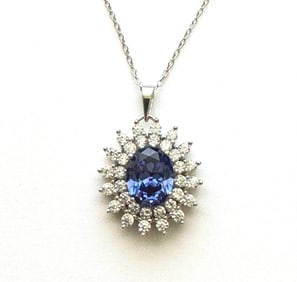Creation Diamond/Tanzanit Pendant 2.98 Ct 18k W/g Overlay: Gem: Creation Diamond/Tanzanite Item:Pendant Center stone: 2.50 carat Oval shape, size 10.5x8.5 mm (Clarity: VSI, Color: Dark Violet Blue) Creation Diamond: .48 carat round (Clarity: VSI, Color: E)