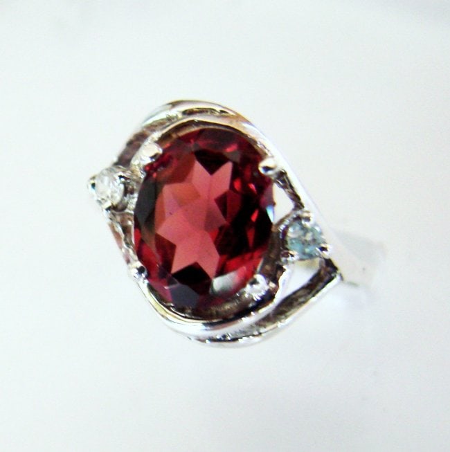 Anniversary Ring Natural Diamond Garnet 1.80Ct 14k W/g: Gem Type: Natural Diamond and Garnet Item: Ring (Size: 7) Band thickness: 2-3mm 2 Pieces weight: .10 carat Rounds Brilliant Clarity: SI1, Color: H, Treatment: None Garnet Weight: 1.70 carat oval shape