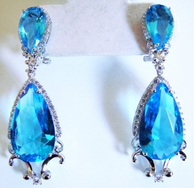 Creation Diamond/Blue Topaz Ear 59.09Ct 18k W/g Overlay: Gem: Creation Diamond/Blue Topaz Item: Earrings Face Size: L2" x W1/2" inch Long Creation Diamond: 2.19 carat Round Brilliant Clarity: VVS, Color: F Creation Topaz:56.90 Carat Pear Facet Measurement:1