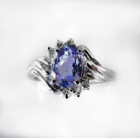 Tanzanite: 1.30 & Diamond: .24CT Ring14k W/g: Gems: Natural Tanzanite Diamonds 6 Pieces Diamond Weight: .24 Carat Round brilliant Clarity: SI2,Color: H, Treatment: None Center: Tanzanite: 1.30 carat, Shape/Cut: Oval Facet Measurement: 8x6 mm Clar