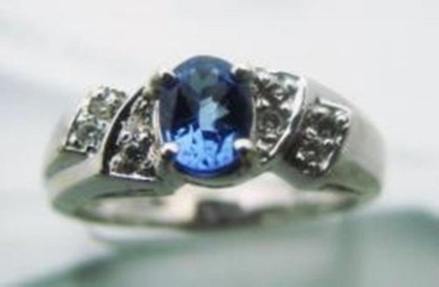 Tanzarnite: 1.10CT, Diamond: .25CT Ring 14k W/G: Stunning Tanzanite Ring Tanzanite Weight: 1.10 Carat Shape: Oval Facet Clarity: VS,Color: Blue/Violet,Treatment: None Origin: Tanzania 8 Pieces Diamond: .25 carat round brilliant Clarity: SI-1 Color: 