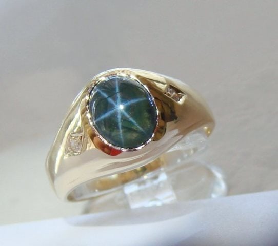 Man Blue Star Sapphire Ring: 2.05CtD:.08Ct 14KY/G: Gems: Natural Cabochon Star Sapphire White Diamond Item: Ring (Size: 8) Weight: .08 carat 2 Pieces Round brilliant Clarity SI3, Color: H, Treatment: None Center: Cabochon Star Sapphire Weight: 2.05 ca