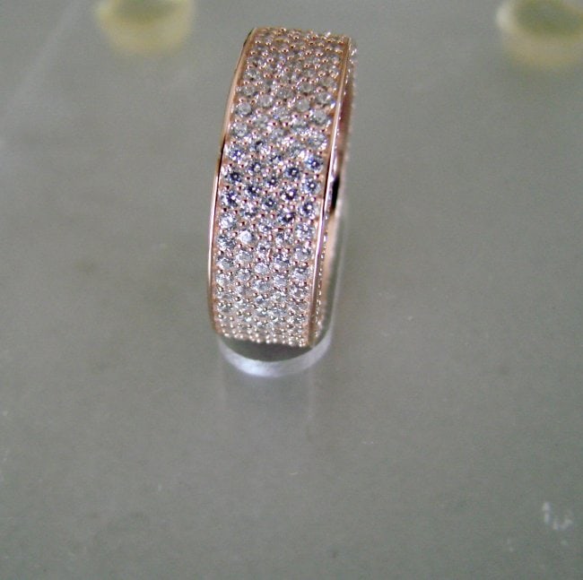 Creation Diamond Eternity Ring 3.16Ct 18k R/g Overlay: Gem: Creation Diamond, Qty: 1 Item: New Color: F Setting name: Micro Pave 18k Rose gold overlay 925 silver Weights: 6.63 grams Polished: Excellent Back Size Design Filigrees Measurement:W