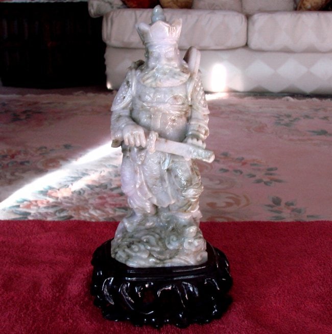 19th Century Jade Carving Famous Dragon Gong Guanyu: Gem:Jade Dragon Gong Guanyu Warrior Statue with a Hand Knife 19th Century Weight: 3.5 Pounds Height: 9" x Width: 3.5" Color: Light green, Dark Green, Brown Texture Stand: Caving Wood color rich burgun