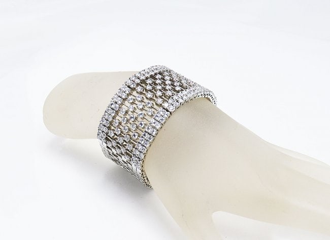 Fashion Jewelry Creation, Diamond18k W/G Overlay: Gem Type: Creation White Diamond Item: Bracelet Clarity: VSI Color: F Metal: 18k White gold overlay Brass Weight: 59.04 grams Length: 7. Inches Width: 1.02 inches Lock: Hidden Safety clasp Style: