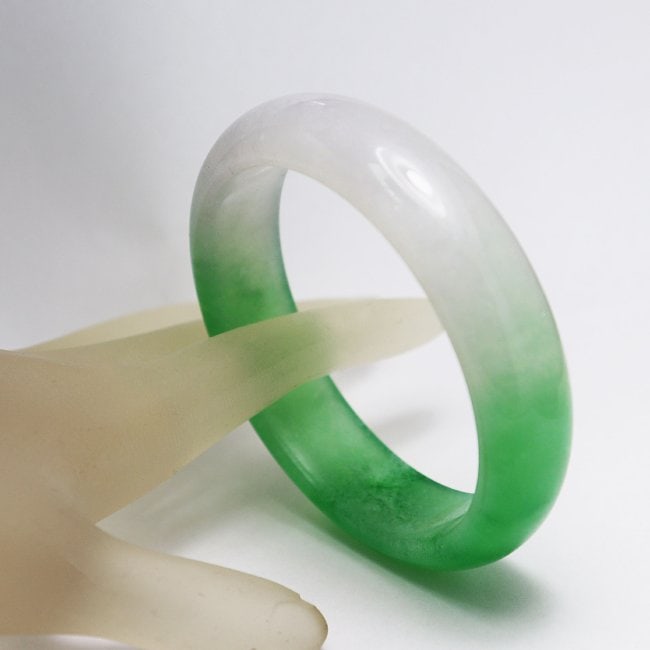 Translucent Solid Green/Creamy Chinese Jade Bangle Size: Gem Type: Natural Translucent Solid Chinese Jade Grade: B Item: Jade Bangle, Size 7 Outer Diameter: 75 mm Inter Diameter: 60mm Width: 16.5 mm Thickness: 8.5 mm Weight : 61.78grams Treated: Untreated