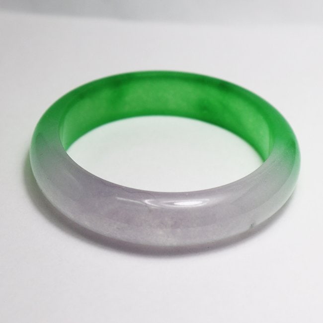 Translucent Solid Green/Violet Chinese Jade Bangle Size: Gem Type: Natural Translucent Solid Chinese Jade Grade: B Item: Jade Bangle, Size 7 Outer Diameter: 75 mm Inter Diameter: 60mm Width: 16. 4mm Thickness: 8.6 mm Weight 63.29 grams Treated: Untreated