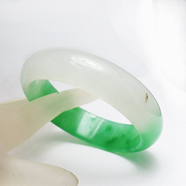 Translucent Solid Green/Creamy Chinese Jade Bangle Size: Gem Type: Natural Translucent Solid Chinese Jade Grade: B Item: Jade Bangle, Size 7 Outer Diameter: 75 mm Inter Diameter: 60mm Width: 17.01mm Thickness: 8.5 mm Weight 63.87 grams Treated: Untreated