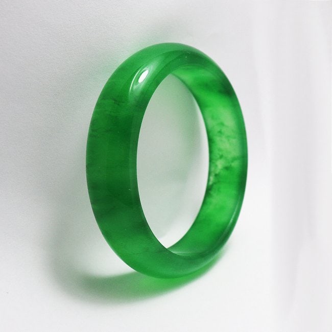 Translucent Solid Green Chinese Jade Bangle Size: 7: Gem Type: Natural Translucent Solid Chinese Jade Grade: B Item: Jade Bangle, Size 7 Outer Diameter: 75mm Inter Diameter: 60mm Width: 16.4 Thickness: 8.5 mm Weight 61.08 grams Treated: Untreated