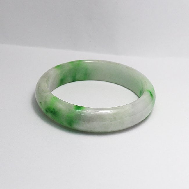 Translucent Solid Green/ Creamy Chinese Jade Bangle: Gem Type: Natural Translucent Solid Chinese Jade Grade: B Item: Jade Bangle, Size 6 Outer Diameter: 74 mm Inter Diameter: 5.8 mm Width: 15mm Color: Green/ Creamy Thickness: 7.6 mm Weight 62.19