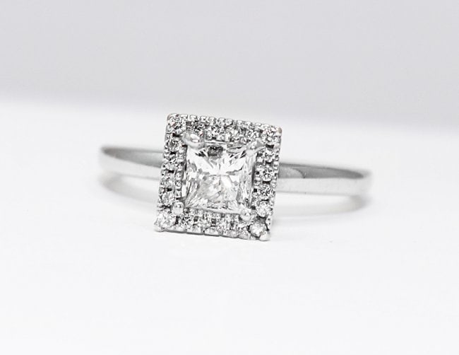 Princess Cut diamond Ring .66 Ct 14k W/G: Gem Type: Natural Diamond Total Diamond Weight: .66 Carat Round Brilliant Center: .50CT Princess Cut, Size: 5x5mm, Clarity: SI2, Color: G-H Small Diamond Surrounding: .16 Carat round brilliant Metal: 
