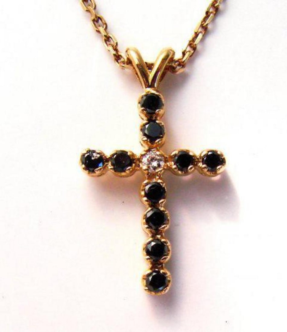 Black&White Diamond Cross Pendaent 1.31Ct 14k Y/g: Gem Type: Natural Black and White Diamond Item: Cross Pendant Center White Diamond 1 Pieces Weight: .11 carat Round Brilliant (Clarity: SI1 Color: H Treatment: None) Black Diamond 10 Pieces Weight: 1.