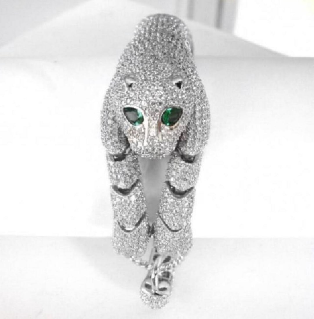 Creation Diamond Juguar Bracelet 23.05Ct 18kW/g Overaly: Creation Diamond & Green Garnet Qty: 1 Item: Bracelet Weight: 21.40 Carat Round Brilliant Clarity: VVS, Color: F Green Garnet:1.25 Carat Pear Cut Clarity: VVS, Color: Green Setting: Micro Pave Metal: