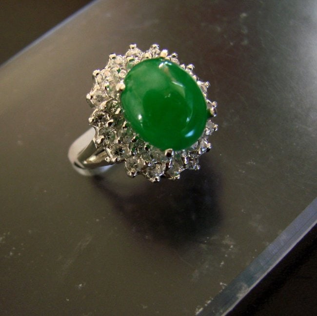 Anniversary Ring Imperial Jade/Diamond 7.53Ct 14k W/g: Gem: Natural Imperial Jade & Diamond Item: Ring Ring face diameter: 17x18.5 mm Jade Weight: 5.91 Carat Oval Cabochon Measurement: 12x10 mm Grade: A Clarity: Transparent,Color: Emerald Green Treatment: