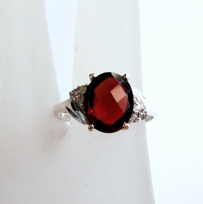 Anniversary Ring Natural Diamond Garnet 3.07Ct 14k W/g: Gem Type: Natural Diamond and Garnet Item: Ring (Size: 7) Band thickness: 2-3mm 6 Pieces weight: .14 carat Rounds Brilliant Clarity: SI1, Color: H, Treatment: None Garnet Weight: 2.93 carat oval shape
