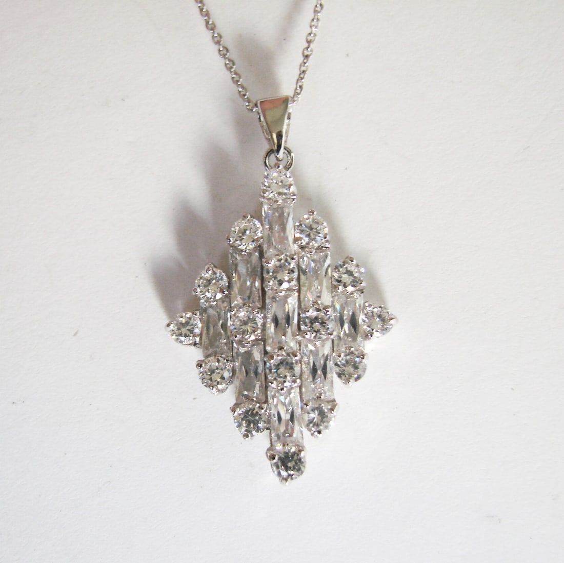 Creation Diamond Pendant 2.15Ct 18k W/g Overlay: Creation Diamond Pendant High Quality Item Item : Pendant Total : 2.15 Carat Baguette and Round (Clarity: VS, Color: F) Setting Prong Length: 1.1/2" x 1?inch 18k White gold Overlay 925 silver