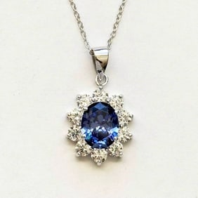 Creation Diamond/Tanzanit Pendant 2.50 Ct 18k W/g Overlay: Gem: Creation Diamond/Tanzanite Item:Pendant Center stone: 2.15 carat Oval shape, size 10x8 mm (Clarity: VSI, Color: Dark Violet Blue) Creation Diamond: .35 carat round (Clarity: VSI, Color: E) Metal: