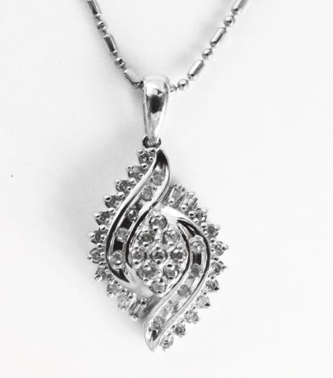 Diamond Unique Pendant: .55 Carat 10k W/g: Gem type: Natural Diamonds Item: Pendants Diamonds 47 Pieces Weight: .48 carat Round brilliant (Clarity: SI2/Color: H/Treatment: None) Diamond Baguette 4 Pieces Weight: .07 Carat (Clarity: SI1/Color: