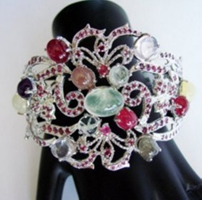 Bangle Natural Gems Multicolor 59.63Ct 18k W/g Overlay: Gem Type: Natural Sapphire Ruby Amethyst Smoky Rose Quartz and Prehnite Item: Bangle (Size: 8.5) Length 2.75" x Width: 2.25" inch 14 Pieces 53.19 Carat Cut/Shape Cabochon Oval Round and Trillion Measu