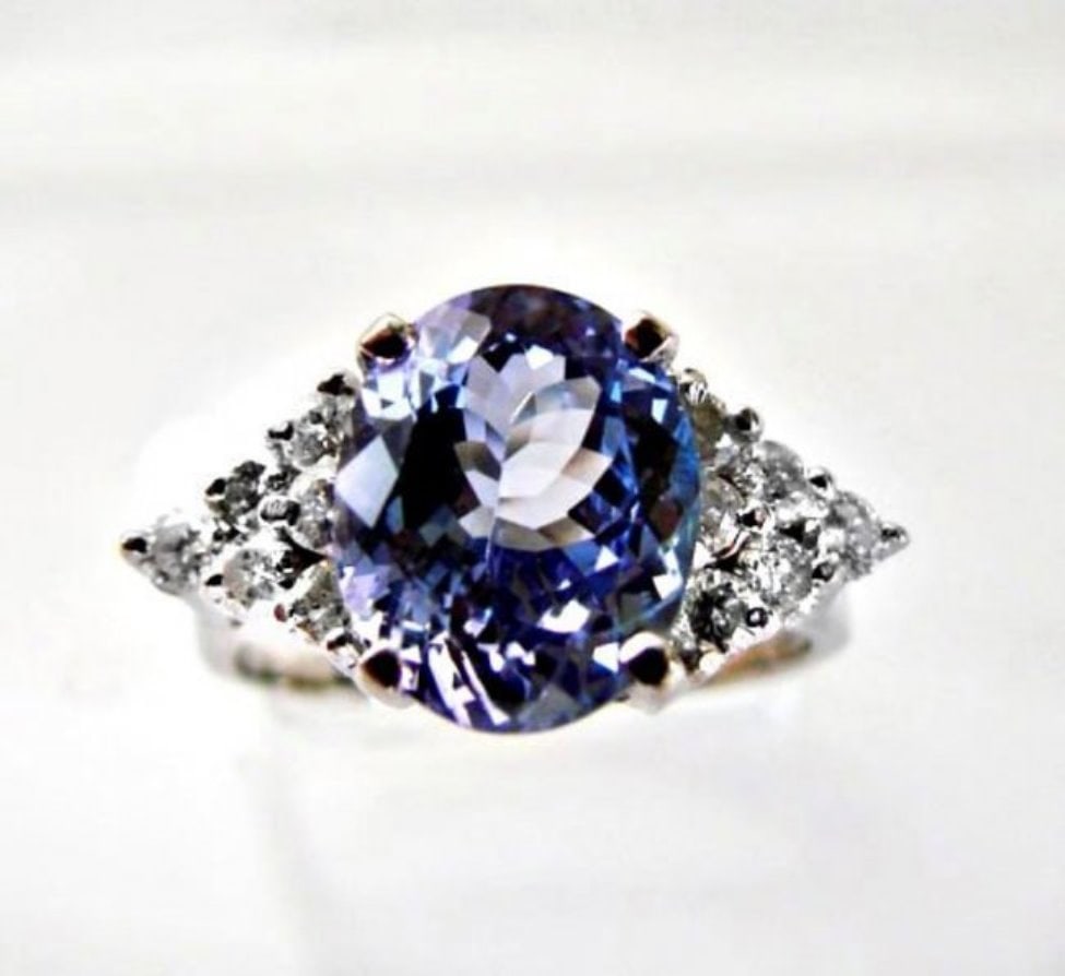 Tanzanite & Diamond Ring 3.90Ct 14k W/G: Gem Type: Natural Tanzanite and Diamond Qty: 1 Condition: New Item: Ring (Size: 6.5) Band thickness: 2-3mm Total diamond weight: .58 carat 12 pieces rounds brilliant Clarity: SI1, Color: H,