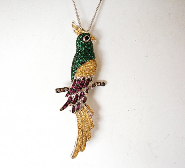 Creation, Dia/Multi-Color Bird 15.63 18k W/g Overlay: Gem Type: Creation, Diamond/ White/ Multi-Color Item Pendant and Brooch Design: Bird Stone total weight: 15.63 carat White Stone: Clarity VS1, Color: F Multi-Color Metal: 18k white gold 7.18 grams Wid