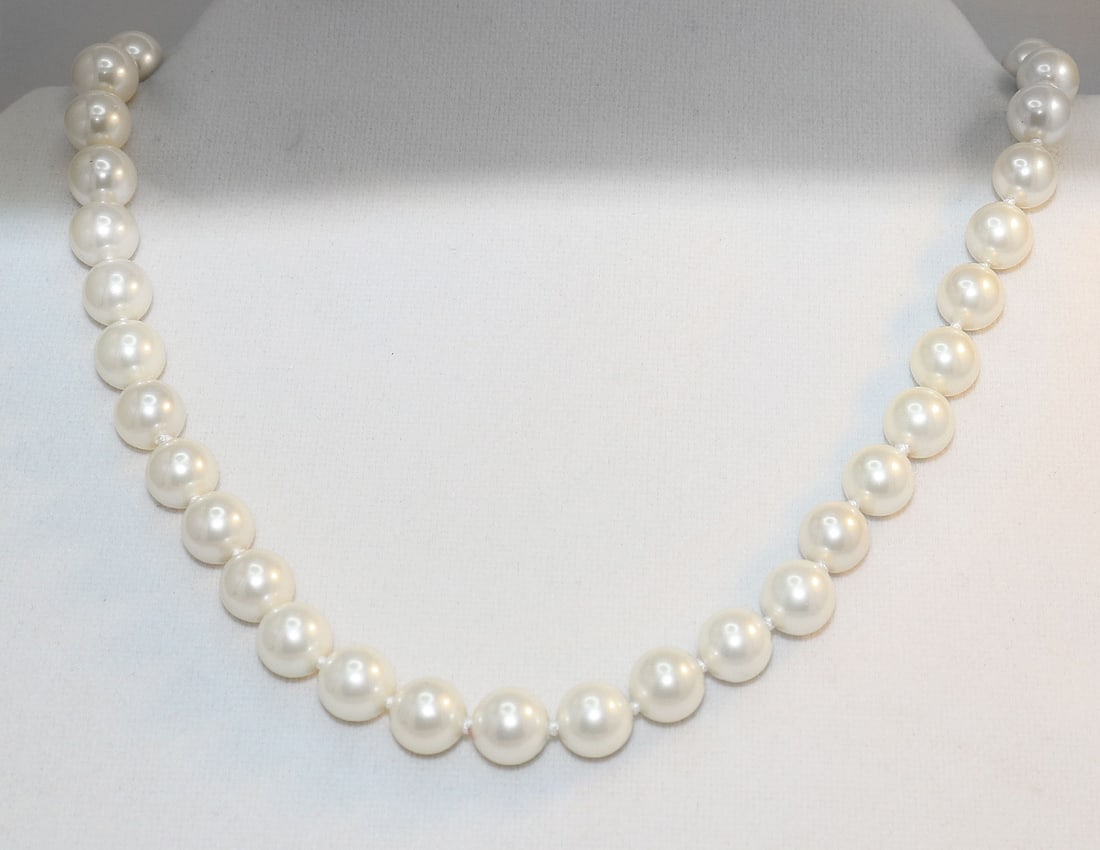 Necklace Swarovski Pearl Necklace 10mm 925 Ball Clasp: Gems Type: Swarovski Crystal Pearl Measurement: 10 mm, 41 pieces Grade: AAA Color: Golden Swarovski Pearl Luster: Excellent Length: 18 Inches Ball Clasp Knot: Each in Between Threat: Silk <