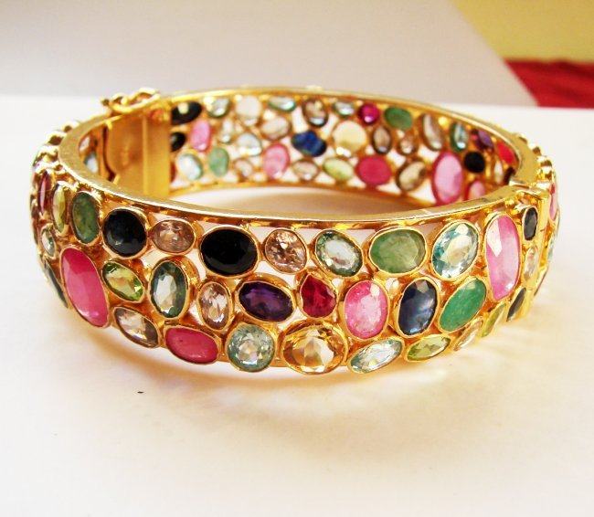 Natural Gems Multicolor Bangle 72.24Ct 18k Y/g Overlay: Gems Type: Natural Beautiful Multicolor Stones High Quality Item Hand made by Handicraft Sapphire, Ruby, Emerald, Blue Zircon, Tourmaline, Garnet, Topaz Weight:72.24 Carat-Item: Bangle Clarity: VS-IS-