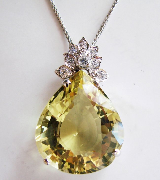 Lemon Topaz Pendant 28.20CT 297x22x13mm: Gem Type: Natural Lemon Topaz/Creation Diamond Quantity: 1 Lemon Topaz: Approx 28.20 Carat (Pear Shaped, Cut: Facet, Size: 27x22x13mm) Clarity: VS1, Color: Medium Yellow, Treatment: None Hardness 7 Or
